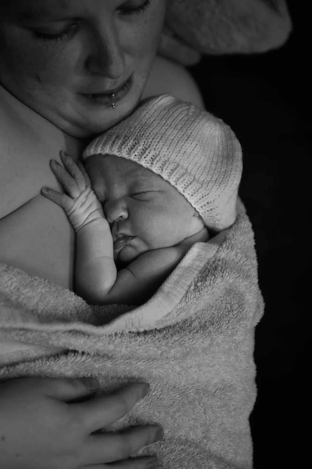 Mother holding a sleeping newborn
